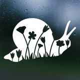 White silhouette of a snail with flowers on a dark background