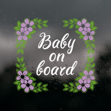 Decorative 'Baby on board' sign with floral elements on a dark background