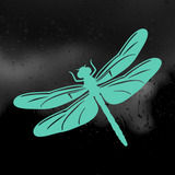 A teal dragonfly decal or sticker shown against a dark, rain-speckled background.