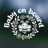 White 'Baby on board' decal with a bee design on a dark background