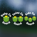 Frog-themed car decal with text 'Baby On Board', 'Twins On Board', and 'Kids On Board' on a rainy window background.