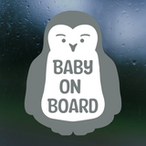 Penguin-shaped 'Baby on Board' sign on a dark background