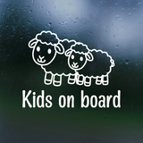 White 'Kids on board' decal with sheep illustrations on a dark surface
