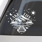 White 'Lake Life' decal with mountain and nature elements on a car window.