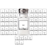 Clear salt shaker with silver top on a white background with spice label designs.