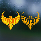 Two yellow phoenix decals on a dark, rain-dotted surface