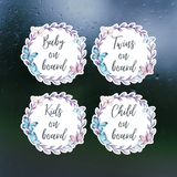 Four round stickers with text 'Baby on board', 'Twins on board', 'Kids on board', and 'Child on board' on a dark background.