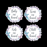 Four round stickers with floral designs and text on a black background