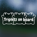 Sticker with 'Triplets on board' text and three duck illustrations on a dark background.