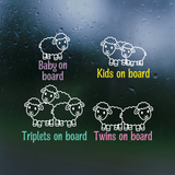 Sheep-themed car window stickers with text indicating pregnancy stages on a dark background.